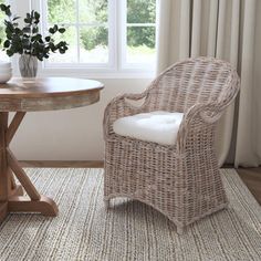 a wicker chair next to a round table