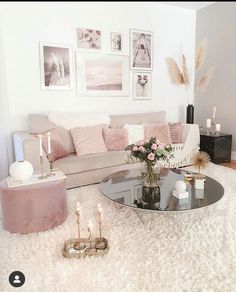 a living room filled with lots of furniture and flowers on top of a white rug