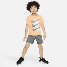 This 2-piece set is an easy way to get your child kitted out for play. Both pieces are made of knit fabric enhanced with quick-drying, moisture-wicking Dri-FIT technology to help little ones stay cool and dry while they move. The graphic tee has a tagless crewneck for easy wear and the matching shorts have a stretch waistband for a comfy fit. Let's go! Casual Breathable Training Sets, Nike Sporty Sports Sets, Playful Nike Sports Sets, Nike Sporty Sets For Playtime, Comfy Fits, Stay Cool, Shorts Set, Grey Fashion, Easy Wear