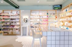 the inside of a pharmacy store with shelves and counter tops filled with medicine bottles on display