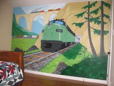 a bedroom with a train mural on the wall