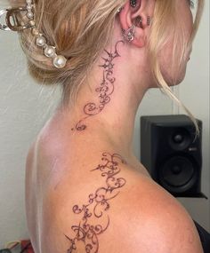 a woman with a tattoo on her back neck