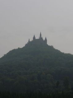 a castle on top of a hill in the distance