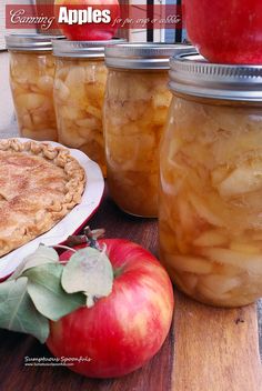 apple pie and apples in jars sitting on a table