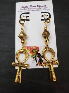 "Beautiful handmade earrings made with high quality gold plated metal Ankh symbol, and nickel free gold plated leverback earwires. Lightweight and easy to wear, these earrings are 3\" long. Please come back and visit to check for more unique new designs and styles For more styles visit my Etsy shop:www.etsy.com/shop/SoftlySisterDesigns" Adjustable Gold Plug Earrings With Ear Wire, Symbolic Gold Nickel-free Earrings, Gold Ankh Metal Jewelry, Gold Ankh Shaped Metal Jewelry, Ankh-shaped Metal Earrings For Gift, Nickel Free Ankh Earrings For Gift, Ankh Shaped Metal Earrings For Gift, Nickel-free Ankh Earrings As Gift, Nickel-free Ankh Gold Earrings