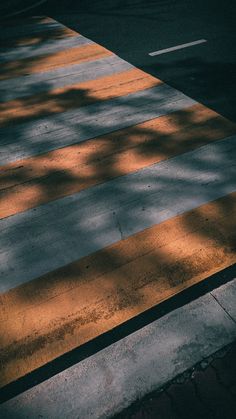 the crosswalk is painted yellow and gray