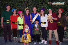 a group of people dressed in costumes posing for a photo with one child and two adults