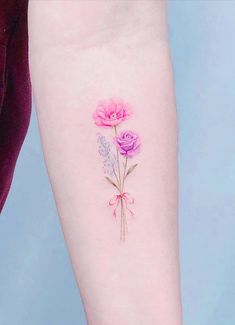 a pink flower tattoo on the left arm