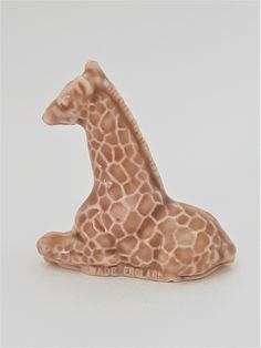 a giraffe figurine sitting on the ground