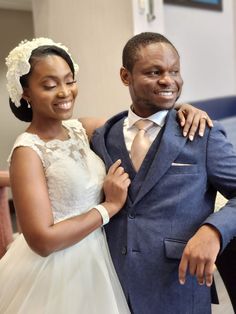 a bride and groom pose for a photo