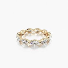 a gold ring with white stones on it