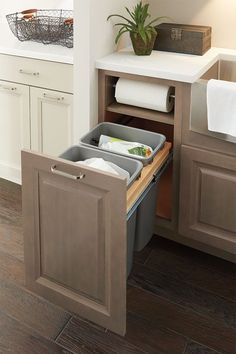 an open cabinet in the middle of a kitchen