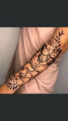 a woman's arm with flowers and butterflies on it