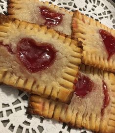 three pastries on a white doily with jelly toppings