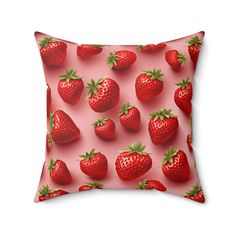 a red pillow with strawberries on it