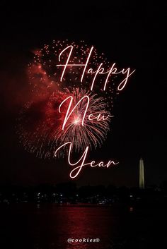 fireworks are lit up in the night sky with happy new year written on it's side