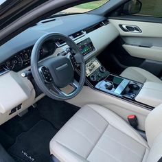 the interior of a car with leather seats and electronic controls on the steering wheel area