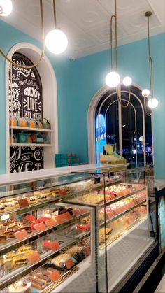 a bakery filled with lots of different types of cakes and pastries in glass cases