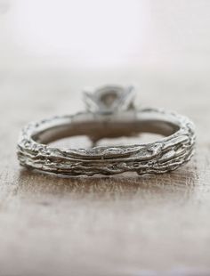 a close up view of a wedding ring on a table