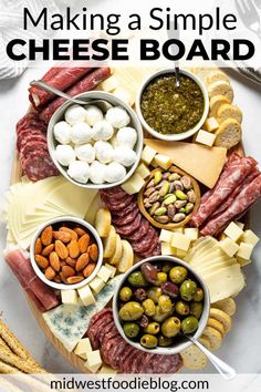 an assortment of cheeses and meats on a platter with the words making a simple cheese board