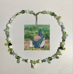 a necklace with an image of pooh and eebi on it