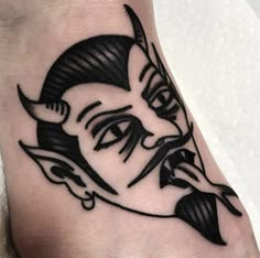 a black and white tattoo on the foot of a person