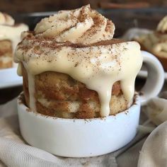 some cupcakes with frosting and cinnamon sprinkles in them on a white plate