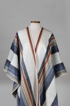 A striking layer over jeans and tall boots. Wrap up and keep warm in this reversible poncho. Handmade by makers with our artisan partner, Camari, working with makers to ensure they receive stable, fair income that enables them to carry on family traditions of working the land and preserving indigenous culture through traditional crafts. Alpaca Shawl, Chain Scarf, Partner Work, Candle Wall Decor, Hooded Poncho, Indigenous Culture, Chevron Stripe, Accessories Bags Purses, Quito