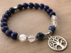 Spiritual Awareness Bracelet, Lapis Lazuli Bracelet, Dumortierite Bracelet, Clear Quartz Bracelet This beautiful bracelet is made of 8mm Lapis Lazuli beads, 8mm Dumortierite beads, 8mm Clear Quartz beads, silver flower spacers, silver spacers and it is adorned with an adorable Tree of Life pendant. The bracelet shown fits to 7.5 inches wrist but you can choose your own wrist size. Clear Quartz *All chakras *Works on all levels of being *Stores information like a natural computer which can be acc Adjustable Sapphire Spiritual Bracelet, Symbolic Round Gemstone Beads Bracelet, Lapis Lazuli Bracelets For Meditation, Adjustable Lapis Lazuli Crystal Bracelet Gift, Blue Round Spiritual Charm Bracelet, Sapphire Lapis Lazuli Bracelets As Gift, Adjustable Lapis Lazuli Crystal Bracelet Spiritual Style, Adjustable Spiritual Lapis Lazuli Crystal Bracelet, Handmade Spiritual Sapphire Bracelets