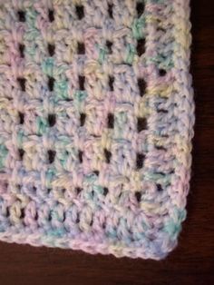 a crocheted dishcloth on a wooden table