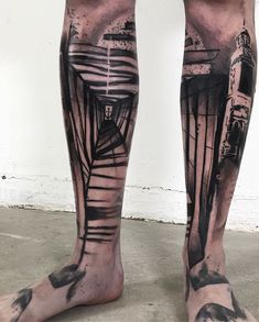 a man with his legs covered in black ink