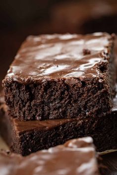 two pieces of chocolate cake sitting on top of each other