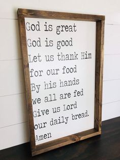 a wooden framed sign with the words god is great written in black ink on it