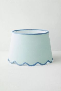 a light blue lamp shade with scalloped edges