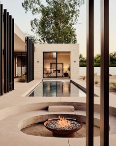 an outdoor fire pit in the middle of a patio