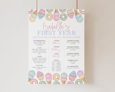 a first year baby shower sign with doughnuts and sprinkles on it