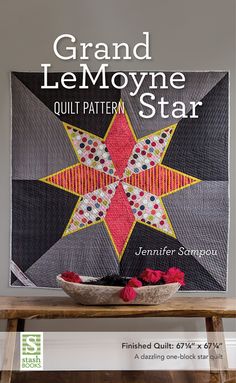 the cover of grand le moyene star quilt pattern is displayed on a table