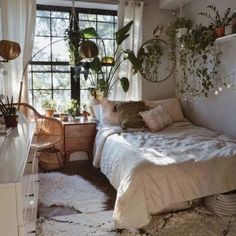 a bed room with a neatly made bed and lots of plants