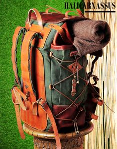 a backpack sitting on top of a wooden table next to a grass covered wall and fence