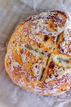 a baked pastry sitting on top of a piece of wax paper with powdered sugar