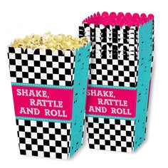 two black and white checkerboard popcorn boxes with pink ribbon on the sides, one is