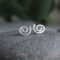 These adorable spiral stud earrings make the perfect gift for anyone with pierced ears. These earrings are perfect for a guy or a girl, anyone with multiple piercings, or just for everyday wear. They are quirky...They are fun! Here are the details about these earrings: The stud earrings are made from sterling silver wire and posts that are approximately 10mm in diameter. These earrings are NOT perfectly uniform...each pair is unique and not-quite-perfect spirals because they are handmade by me! Minimalist Spiral Earrings For Gifts, Minimalist Spiral Earrings As Gift, Unique Spiral Wrap Earrings For Gift, Unique Spiral Wrap Earrings As Gift, Minimalist Swirl Earrings As Gift, Minimalist Swirl Earrings Gift, Silver Spiral Cartilage Earrings As Gift, Spiral Cartilage Earrings As Gift, Trendy Spiral Jewelry As A Gift