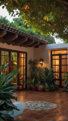 an outdoor patio with potted plants and lights