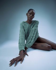 a woman sitting on the floor with her legs crossed