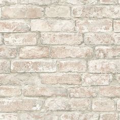 an old brick wall with white paint