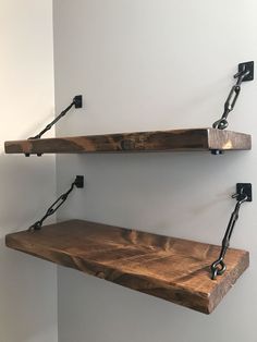 two wooden shelves with metal brackets on them