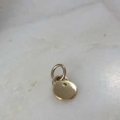 This adorable charm is entirely hand-crafted from recycled 14k gold, which I melt down and form into this petite, organic little pendant. It is then hand-stamped with two sweet leaves and is finished with a genuine flush set diamond. Available with either a shiny gold or satin finish. Includes an open jumpring for hanging. It will be your favorite new spring necklace! *This listing is for one Diamond Petal Charm only. Chain not included and shown with other charms for layering options. :: Solid Dainty Yellow Gold Charms With Birthstone, Dainty Yellow Gold Birthstone Charms, Tarnish Resistant Recycled Gold Round Pendant Charm Necklace, Yellow Gold Charm Necklace With Round Pendant, Minimalist 14k Gold Pendant Charm, Everyday Yellow Gold Pendant Charms, Minimalist Everyday Pendant Charms, Everyday Round Minimalist Charms, Minimalist Everyday Round Charms