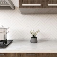 a kitchen counter with a pot on top of it and a stove in the background