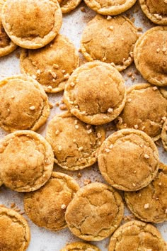 some cookies that are on top of a white surface with brown sugar sprinkles