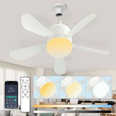 a ceiling fan with remote control and multiple images on the wall in front of it